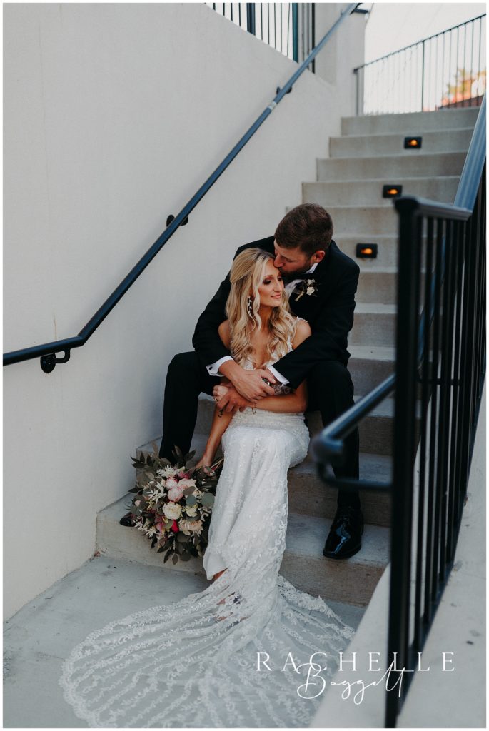 bride and groom sitting on stairs