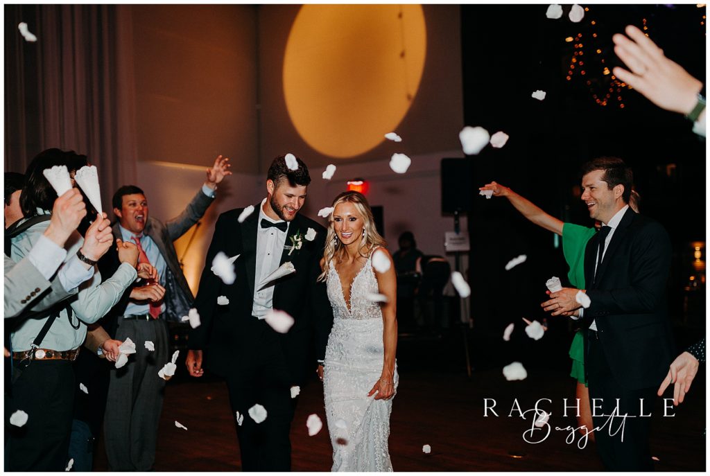 husband and wife exiting with petal toss